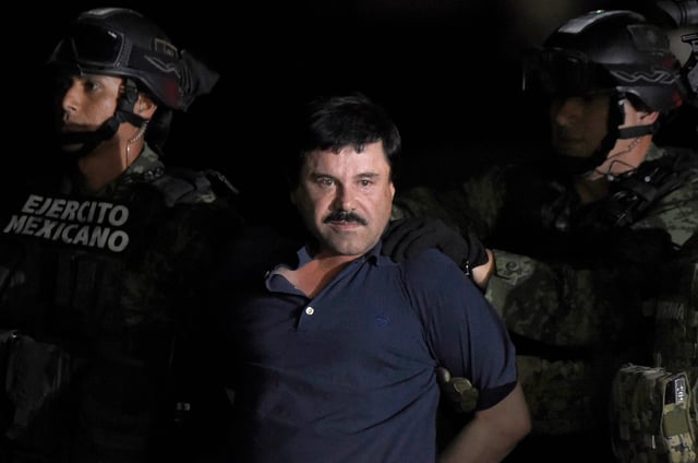 Drug kingpin Joaquin "El Chapo" Guzman is escorted into a helicopter at Mexico City's airport on January 8, 2016, following his recapture during an intense military operation in Los Mochis, in Sinaloa State, Mexico