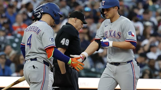May 10, 2025; Detroit, Michigan, USA; Texas Rangers shortstop Corey Seager (5) receives congratulations from designated hitter Joc Pederson (4) after he hits a home run in the sixth inning against the Detroit Tigers at Comerica Park.