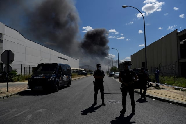 Police blocking a road in Alcala de Guadaira after the fire at a chemical depot