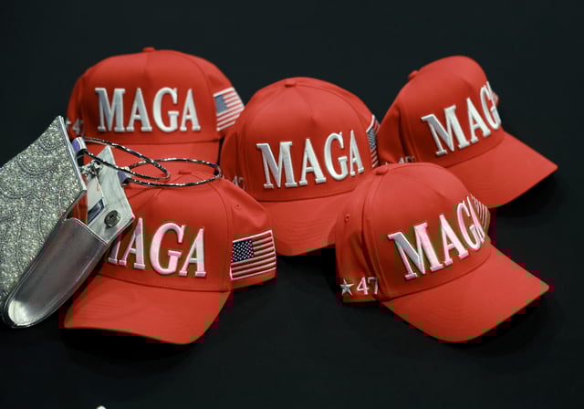 MAGA hats sit on a table during the election night watch party for Republican presidential nominee Donald Trump at the Palm Beach County Convention Center on November 05, 2024, in West Palm Beach, Florida.