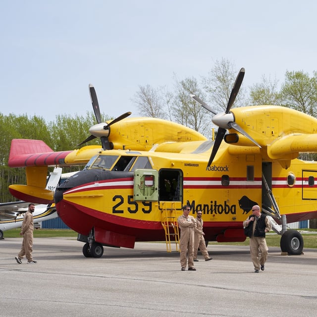 Firefighters arrive at the Flin Flon airport, as wildfires burn in northern Manitoba on Tuesday, May 14, 2024. THE CANADIAN PRESS/David Lipnowski