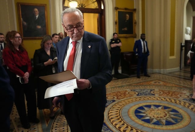 Senate Minority Leader Charles Schumer looks at papers before speaking to reporters following the weekly Senate luncheon at the U.S. Capitol on May 13, 2025, in Washington, D.C.