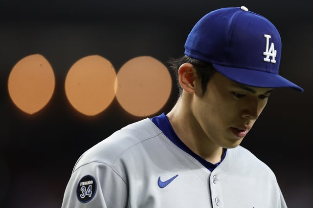 PHOENIX, ARIZONA - MAY 09: Starting pitcher Roki Sasaki #11 of the Los Angeles Dodgers walks to the dugout during the second inning of the MLB game at Chase Field on May 09, 2025 in Phoenix, Arizona.