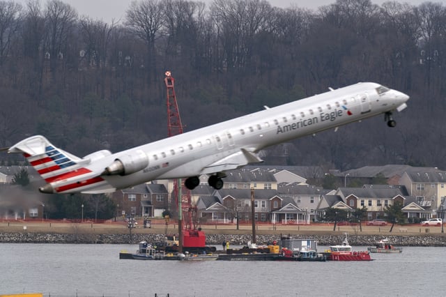 FILE - Salvage crews work on recovering wreckage near the site in the Potomac River of a mid-air collision between an American Airlines jet and a Black Hawk helicopter at Ronald Reagan Washington National Airport, Thursday, Feb. 6, 2025, in Arlington, Va. (AP Photo/Jose Luis Magana, File)