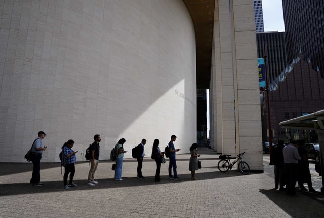 Commuters file under the shade Tuesday while waiting for bus in downtown Houston. Houston temperatures reached a high of 95, shattering the city’s 118-year-old daily heat record for May 13.