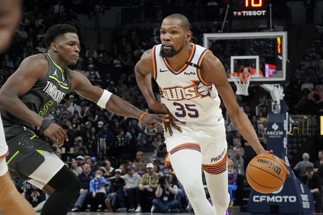 Mar 28, 2025; Minneapolis, Minnesota, USA; Phoenix Suns forward Kevin Durant (35) brings the ball up as Minnesota Timberwolves guard Anthony Edwards (5) defends him in the fourth quarter at Target Center. Mandatory Credit: Bruce Kluckhohn-Imagn Images/File Photo