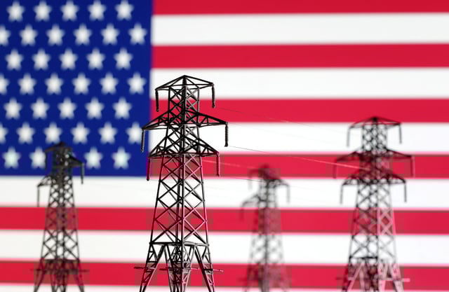 Electric power transmission miniatures are seen in front of displayed U.S. flag in this illustration taken, December 5, 2022. REUTERS/Dado Ruvic/Illustration/ File Photo