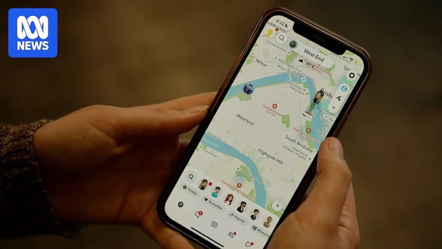 A person holds a phone showing an avatar on a map.