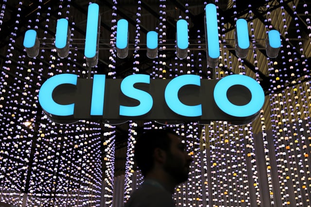 A man passes under a Cisco logo at the Mobile World Congress in Barcelona, Spain February 25, 2019. REUTERS/Sergio Perez/ File Photo