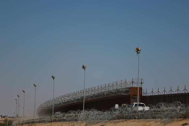 A U.S. Border Patrol vehicle conducts surveillance near a section of the U.S.-Mexico border wall, as seen from Ciudad Juarez, Mexico May 5, 2025. REUTERS/Jose Luis Gonzalez/File Photo