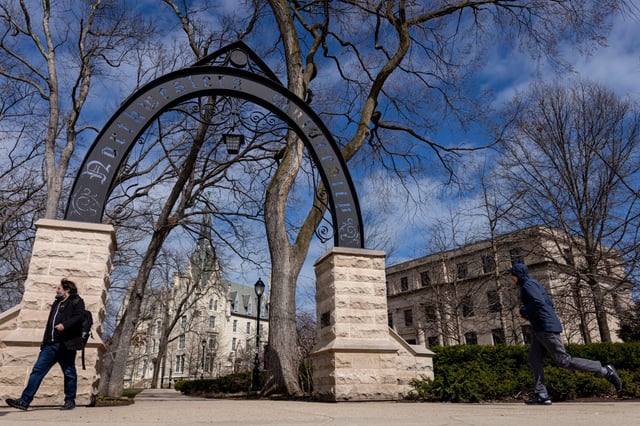 People walk by the arch on the Northwestern University campus, March 31, 2025, in Evanston. (Brian Cassella/Chicago Tribune)