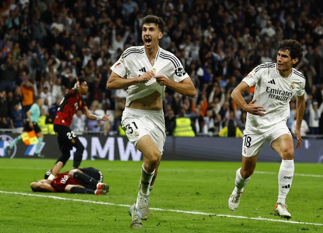 Soccer Football - LaLiga - Real Madrid v RCD Mallorca - Santiago Bernabeu, Madrid, Spain - May 14, 2025 Real Madrid's Jacobo Ramon celebrates scoring their second goal with Real Madrid's Jesus Vallejo REUTERS/Susana Vera