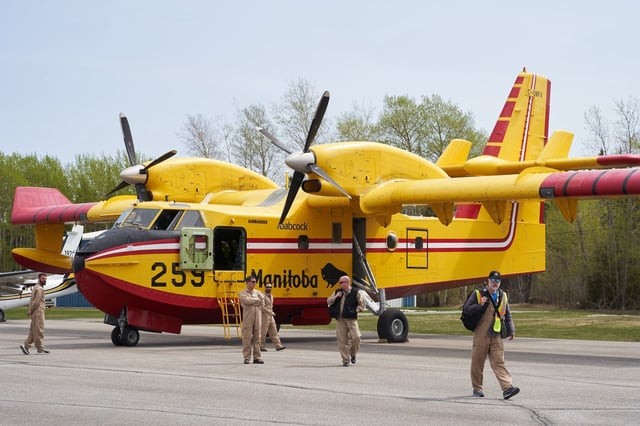 Firefighters arrive at the Flin Flon airport, as wildfires burn in northern Manitoba on May 14, 2024. About 1,000 people were to leave a popular area for cottagers as wildfires continued to burn in Manitoba. THE CANADIAN PRESS/David Lipnowski