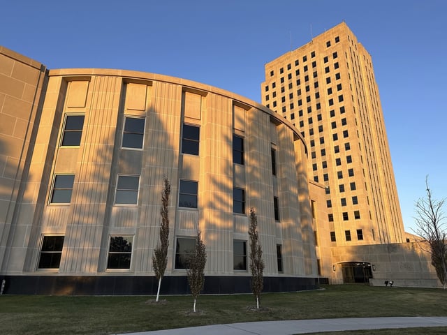 FILE - Sunlight illuminates the exterior of the North Dakota House of Representatives and the state Capitol tower in Bismarck, N.D., on Nov. 10, 2023. (AP Photo/Jack Dura, File)