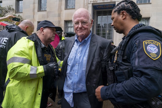 Ben Cohen, co-founder of Ben &amp; Jerry&#39;s, center, is arrested by Department of Homeland Security Police for blocking the entrance to the Department of Justice, after first burning a replica of the Bill of Rights in protest of the Justice Department&#39;s prosecution of Wikileaks founder Julian Assange, Thursday, July 6, 2023, during a protest outside the Department of Justice in Washington.