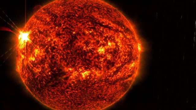NASA’s Solar Dynamics Observatory captured this image of a solar flare — seen as the bright flash on the left – on May 14.