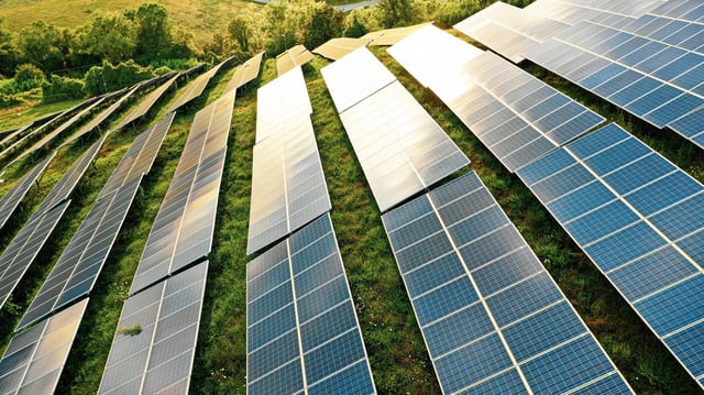 Solar panels fields on the green hills stock photo