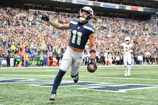 Jaxon Smith-Njigba #11 of the Seattle Seahawks scores a touchdown in the first quarter of the game against the Arizona Cardinals at Lumen Field on October 22, 2023 in Seattle, Washington.