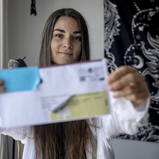 Emmanuelle Bosse holds the letter that was returned by Canada Post, in Terrebonne, Que., on May 15.