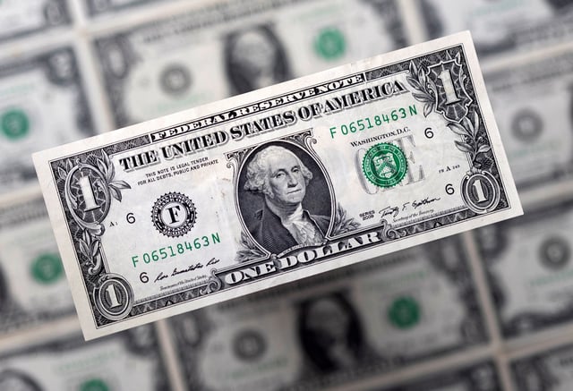 U.S. dollar banknotes are displayed in this illustration taken, February 14, 2022. REUTERS/Dado Ruvic/Illustration/File Photo