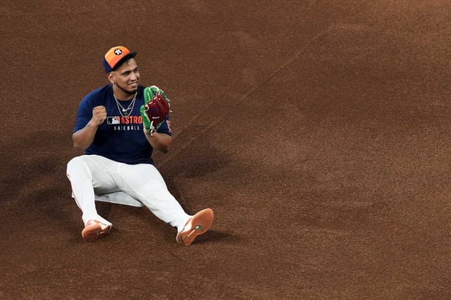 Houston Astros third baseman Isaac Paredes (15) pounds his glove on the dirt before an MLB baseball game at Daikin Park in Houston, Wednesday, May 14, 2025.