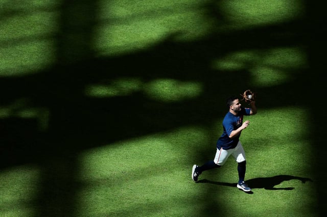 Houston Astros left fielder Jose Altuve (27) fields a fly ball during warmups before an MLB baseball game at Daikin Park in Houston, Wednesday, May 14, 2025.