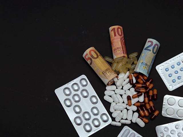 Pills and capsules in euro banknotes.