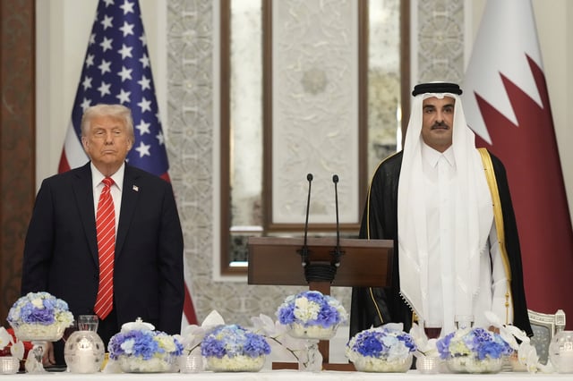 President Donald Trump and Qatar's Emir Sheikh Tamim bin Hamad Al Thani stand during the U.S. national anthem at a state dinner at Lusail Palace in Doha, Qatar, Wednesday, May 14, 2025. (AP Photo/Alex Brandon)