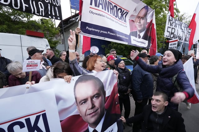 People carry placards in support of conservative presidential candidate Karol Nawrocki in Warsaw, Poland, Tuesday, May 13, 2025. (AP Photo/Czarek Sokolowski)