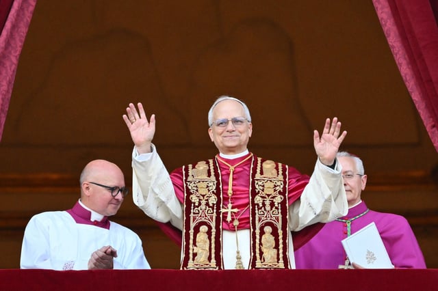 TOPSHOT - Newly elected Pope Leo XIV, Robert Francis Prevost arrives on the main central loggia balcony of the St Peter's Basilica for the first time, after the cardinals ended the conclave, in The Vatican, on May 8, 2025. Robert Francis Prevost was on Thursday elected the first pope from the United States, the Vatican announced. A moderate who was close to Pope Francis and spent years as a missionary in Peru, he becomes the Catholic Church's 267th pontiff, taking the papal name Leo XIV. (Photo by Alberto PIZZOLI / AFP) (Photo by ALBERTO PIZZOLI/AFP via Getty Images)