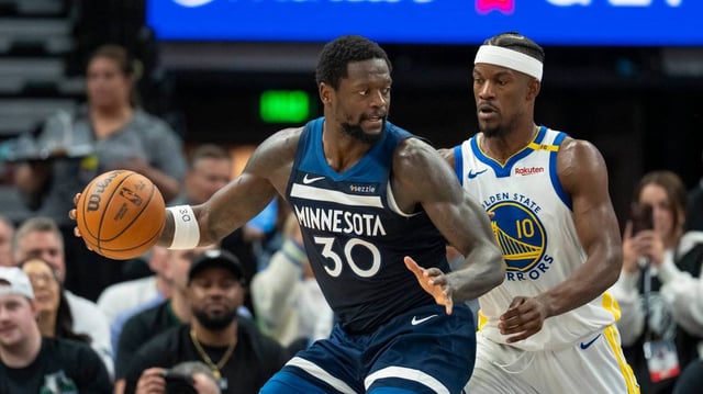 Minnesota Timberwolves forward Julius Randle (30) backs towards the basket as Golden State Warriors forward Jimmy Butler III (10) plays defense in the second half during game five of the second round for the 2025 NBA Playoffs at Target Center.