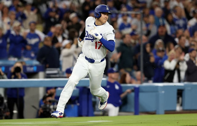 May 14, 2025; Los Angeles, California, USA; Los Angeles Dodgers designated hitter Shohei Ohtani (17) scores during the eighth inning against the Athletics at Dodger Stadium. Mandatory Credit: Jason Parkhurst-Imagn Images