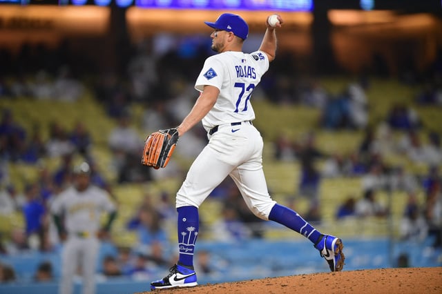 May 13, 2025; Los Angeles, California, USA; Los Angeles Dodgers second baseman Miguel Rojas (72) throws in relief against the Athletics during the ninth inning at Dodger Stadium. Mandatory Credit: Gary A. Vasquez-Imagn Images