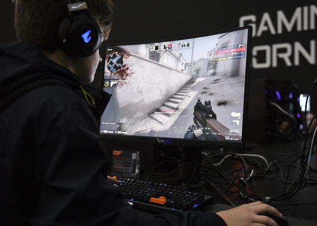 File photo of a young man gaming, taken at the Comic Con festival, in Moscow, Russia, 2019.