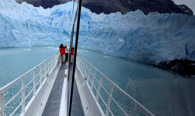 The Perito Moreno glacier is seen reflected in the window of a tourist boat, near the city of El Calafate in the Patagonian province of Santa Cruz, Argentina April 22, 2025. REUTERS/Bernat Parera/File Photo