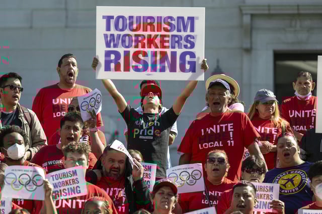 File photo: people cheer and hold signs during a rally outside Los Angeles City Hall to demand an immediate wage increase for tourism workers ahead of the 2028 Olympics in the city on July 30, 2024.