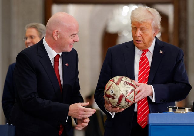 U.S. President Donald Trump holds a soccer ball as he attends an event with Qatar's Emir Tamim bin Hamad Al Thani (not pictured) and FIFA President Gianni Infantino, at Lusail Palace in Lusail, Qatar, May 14, 2025. REUTERS/Brian Snyder