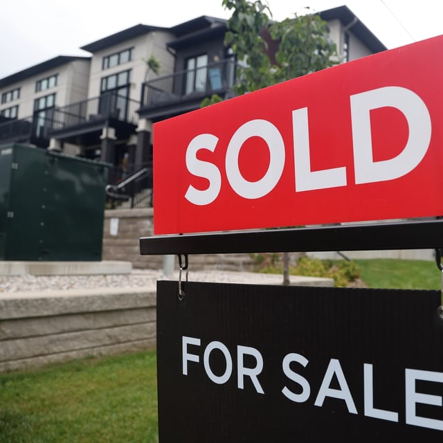 A for sale/sold sign stands in front of residential homes in the Riverside South neighbourhood of Ottawa on Friday, Aug. 30, 2024. THE CANADIAN PRESS/ Patrick Doyle