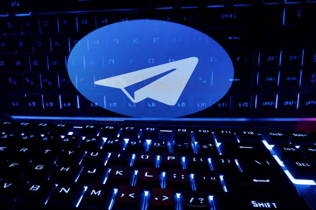 A keyboard is placed in front of a displayed Telegram logo in this illustration taken February 21, 2023. REUTERS/Dado Ruvic/Illustration