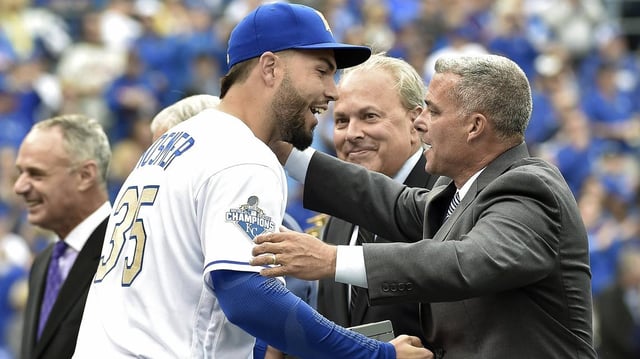 Kansas City Royals first baseman Eric Hosmer, left, moves to embrace general manager Dayton Moore in April 2016 during the club’s on-field World Series ring ceremony at Kauffman Stadium. Commissioner Rob Manfred is in the far left of the frame.
