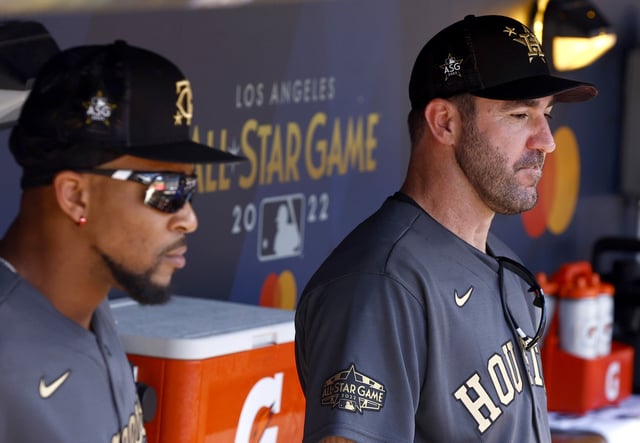 Byron Buxton #25 of the Minnesota Twins and Justin Verlander #35 of the Houston Astros look on from the dugout before the 92nd MLB All-Star Game presented by Mastercard at Dodger Stadium on July 19, 2022 in Los Angeles, California.