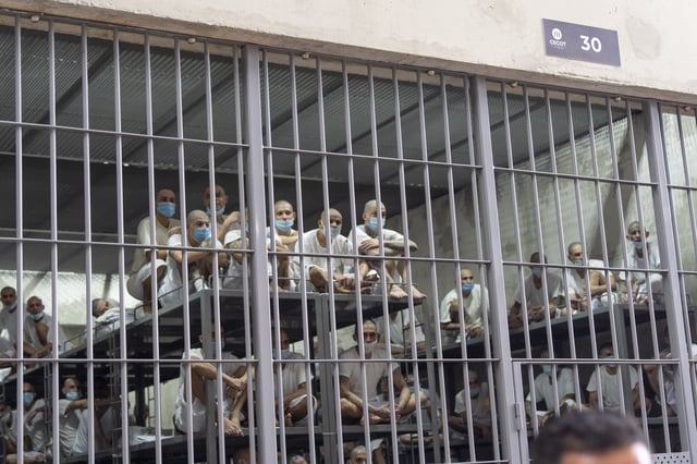 FILE - Prisoners look out of their cell as Homeland Security Secretary Kristi Noem tours the Terrorist Confinement Center in Tecoluca, El Salvador, March 26, 2025. (AP Photo/Alex Brandon, File)