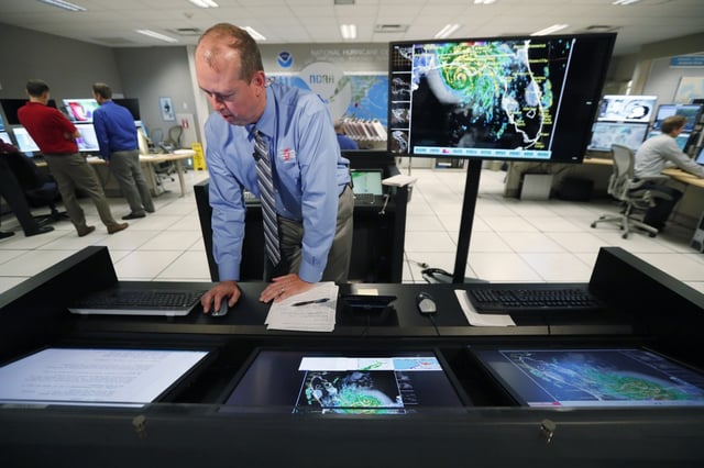 National Hurricane Center director Ken Graham prepares for the next televised update on the status of Hurricane Michael, Wednesday, Oct. 10, 2018, at the Hurricane Center in Miami.  (AP Photo/Wilfredo Lee)