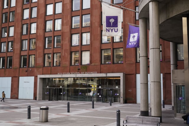 FILE - Pedestrians walk near an NYU building in New York, Dec. 16, 2021. (AP Photo/Seth Wenig, file)