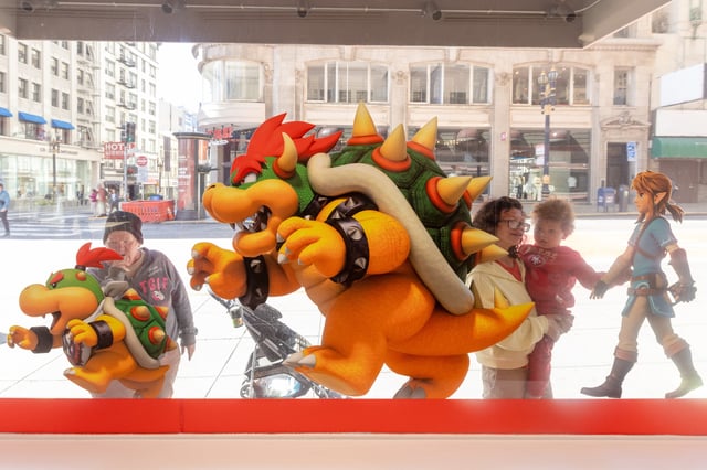 Pedestrians outside check out Nintendo characters placed on the window of the new Nintendo Store in San Francisco’s Union Square on May 14, 2025.