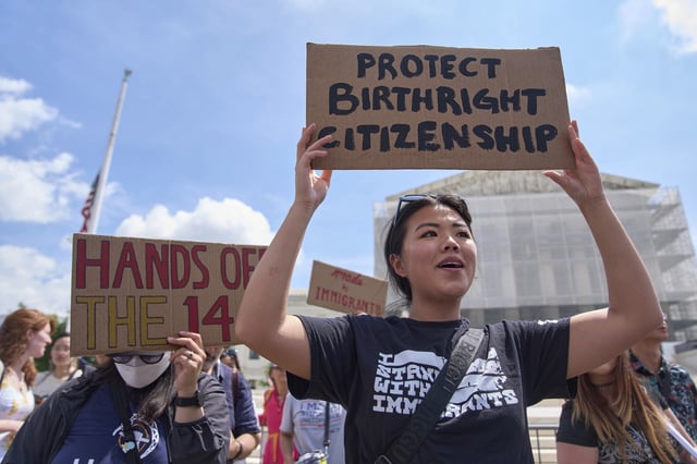 Hannah Liu, 26, of Washington, holds up a sign in support of birthright citizenship, Thursday, May 15, 2025, outside of the Supreme Court in Washington. "This is enshrined in the Constitution. My parents are Chinese immigrants," says Liu. "They came here on temporary visas so I derive my citizenship through birthright." (AP Photo/Jacquelyn Martin)