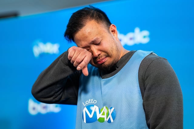 Justin Simporios from Surrey tears up during an announcement for the British Columbia Lottery Corporation's $80 million lottery winner in Vancouver on Thursday, May 15, 2025. THE CANADIAN PRESS/Ethan Cairns
