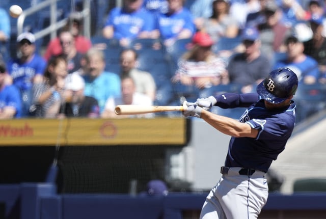 Tampa Bay Rays second base Brandon Lowe (8) hits a two-run home run against the Toronto Blue Jays during first inning American League MLB baseball action in Toronto on Thursday, May 15, 2025. THE CANADIAN PRESS/Nathan Denette