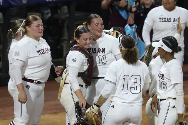 Texas A&amp;M pitcher Emiley Kennedy (11) and Texas A&amp;M infielder Mac Barbara (31) hug after beating Texas in the SEC tournament.