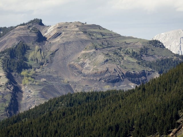 Grassy Mountain, peak to left, and the Grassy Mountain Coal Project are seen north of Blairmore, Alta., Thursday, June 6, 2024.